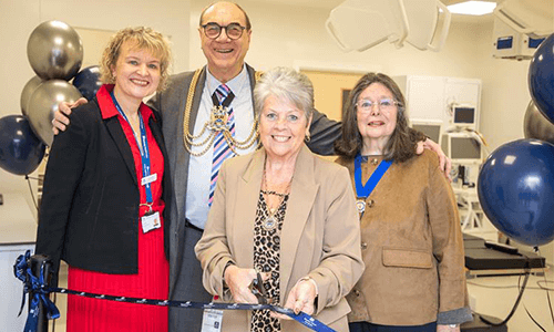 four people smiling with balloons