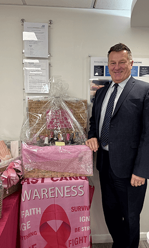 man smiling with hampers