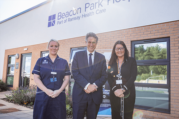 nurse, MP and hospital director smiling