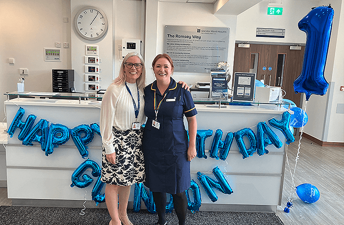 hospital workers smiling at a desk