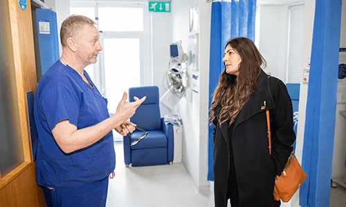 man and woman talking in hospital