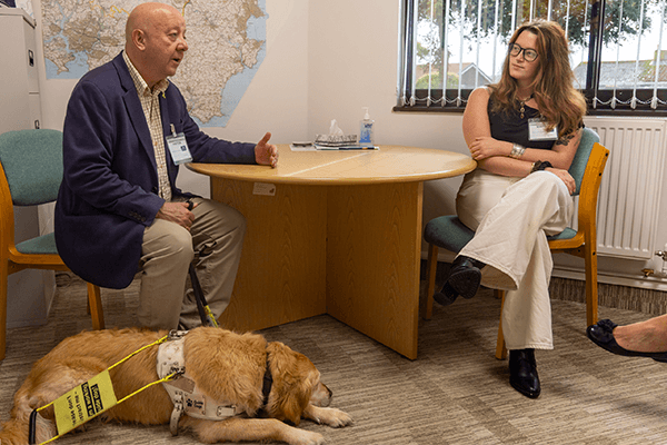 man and woman talking with dog