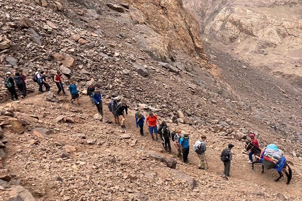 school group hiking on rough terrain