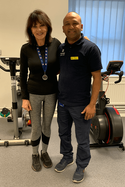 man and woman smiling in the gym